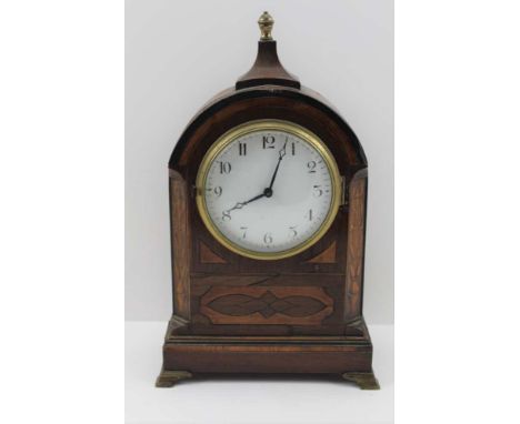 A 19TH CENTURY MAHOGANY CASED MANTEL CLOCK, domed top with finial, circular enamel dial with Arabic numerals, raised on brass