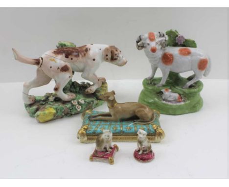 A 19TH CENTURY DERBY CERAMIC POINTER, en passant before a tree stump, upon a flower encrusted base, a 19th century PEARLWARE 