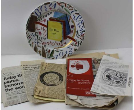 A RUSSIAN CERAMIC PLATE, with hand-painted decoration of books, flowers, a hammer, dated 1921, printed and painted marks to b