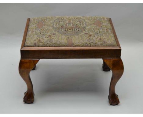 A GEORGIAN DESIGN WALNUT STOOL, raised on cabriole supports with ball &amp; claw feet, tapestry upholstered seat 
