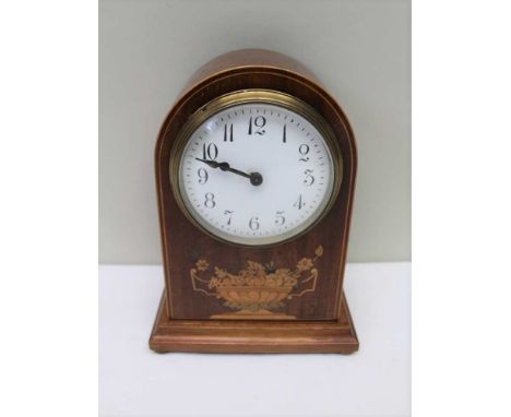 A MAHOGANY ARCH TOP MANTEL CLOCK, marquetry inlaid decoration, white enamel dial with Arabic numerals, raised on brass bun fe