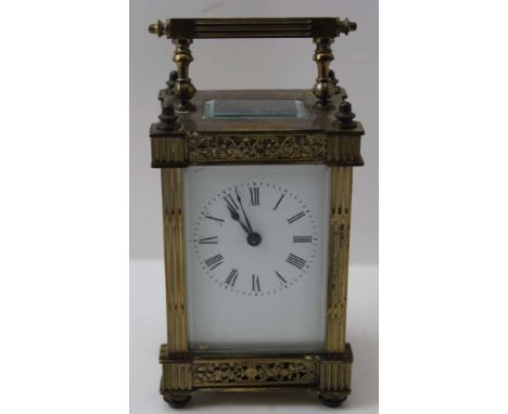 A 19TH CENTURY BRASS FRAMED CARRIAGE CLOCK white enamel dial with Roman numerals, bevel plate glass panels inset, 13cm high 