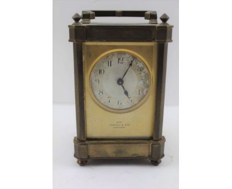 A BRASS FRAMED CARRIAGE CLOCK, with bevel glass panels, silvered dial with Arabic numerals inscribed "Thomas &amp; Son Cardig