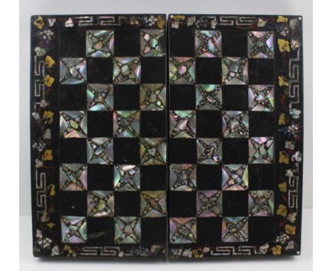 A MID 19TH CENTURY PAPIER MACHE MOTHER-OF-PEARL INLAID AND OVER PAINTED CHESS BOARD, having hinged folding mechanism, with ba