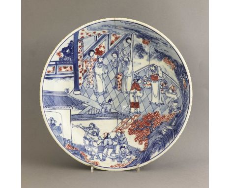 A Chinese copper red and underglaze-blue charger,Kangxi (1662-1722), the shallow rounded sides rising from a channelled circu