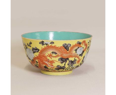 A Chinese famille rose bowl,late Qing dynasty, the rounded sides rising from a circular foot, painted with two dragons among 