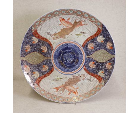 A large Japanese Imari charger,Meiji period (1868-1912), the centre painted with a chrysanthemum roundel, surrounded by carp 