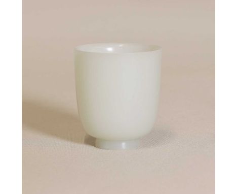 A Chinese jade cup,Qing dynasty (1644-1911), of cylindrical form on an everted foot, plain, the stone of greyish-white tone,6