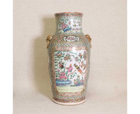 A Chinese Canton famille rose vase,late 19th century, of tapering form flanked by two mask and ring handles, painted with phe