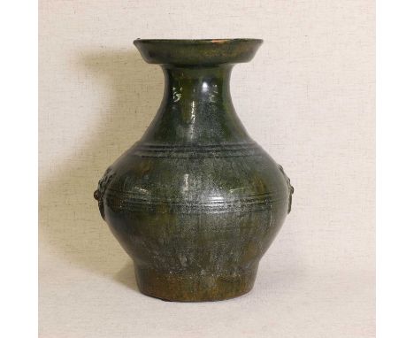 A Chinese lead-glazed stoneware vase, Han dynasty (206 BC-AD 220), the bulbous body with mask and ring handles under a spinac