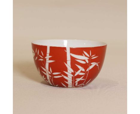 A Chinese coral-ground bowl, 19th-20th century, the body with deep rounded sides covered in coral-red enamel decorated in res