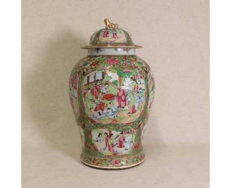 A Chinese Canton enamelled famille rose vase and cover,19th century, of baluster form, painted with figures in a garden in sh