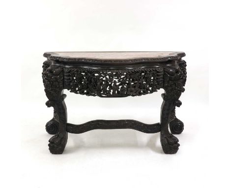 A Chinese hardwood console table,19th century, the top inserted with rouge marble above S-shaped legs carved with dragons and