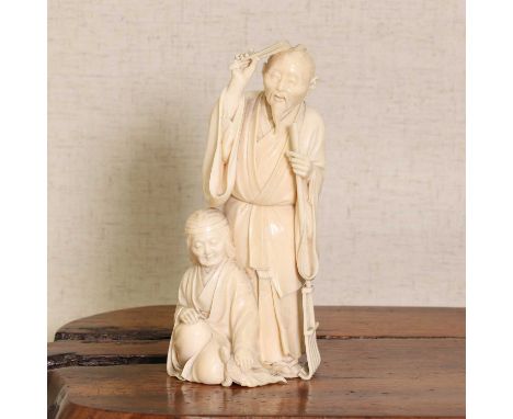A Japanese ivory okimono,Meiji period (1868-1912), carved with an elderly man standing with a leaf rake in his left hand, an 