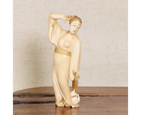 A Japanese ivory okimono,Meiji period (1868-1912), carved with a lady loosely wearing a yukata exposing half of her chest, a 