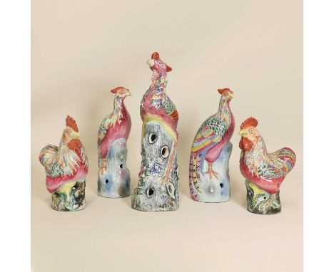 A collection of three Chinese famille rose phoenixes, early 20th century, moulded with the bird perched on a pierced rock, 20