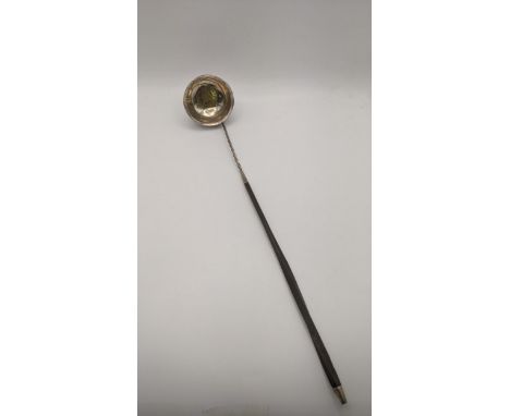 An 18th/19th century silver coloured metal and gilt coin toddy ladle with a whale bowl spoon Location:If there is no conditio