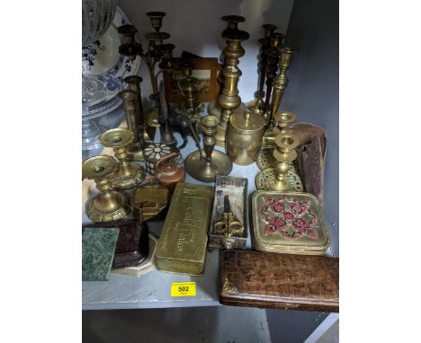 A selection of mixed brassware to include pairs of candlesticks, a leather box with gold coloured corner mounts, mirror to in