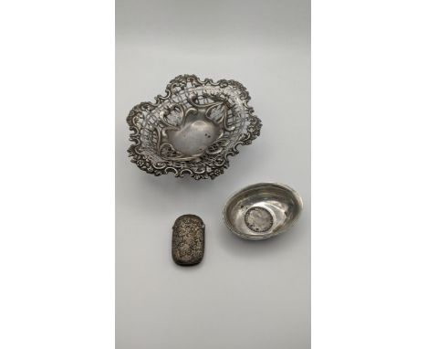 Silver to include a William Comyns and Sons pierced pin dish, hallmarked London 1891, a floral embossed vesta case and a Geor