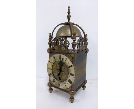 An early 20th century reproduction of a 17th century brass cased lantern clock, having strap work bell and pierced fretsLocat