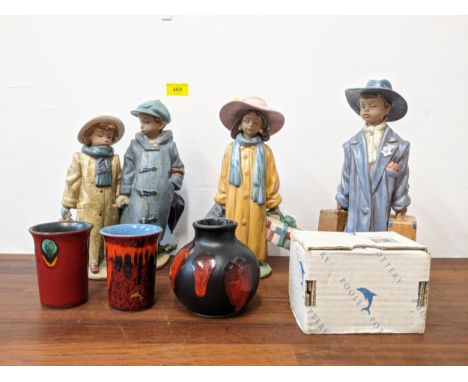 Three Lladro figures, one of a boy holding two suitcases, the other of a girl holding a suitcase and hatbox, one of a couple 