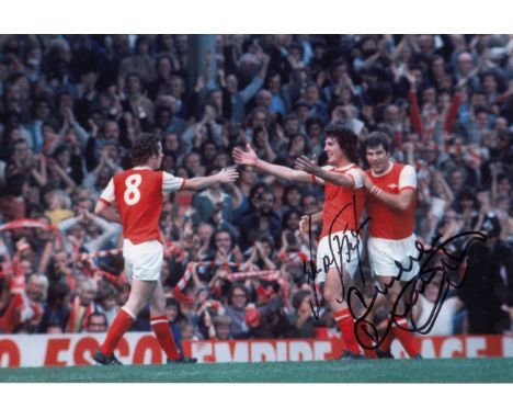 Autographed Arsenal 12 X 8 Photo : Col, Depicting Arsenal's Liam Brady And Malcolm Macdonald Celebrating With Frank Stapleton