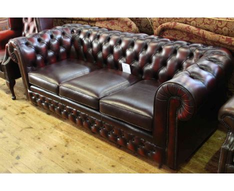 Ox blood deep buttoned leather three seater Chesterfield settee by Thomas Lloyd.