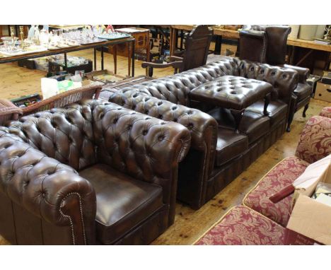 Brown buttoned leather four piece Chesterfield suite comprising three seater settee, wing armchair, Chesterfield chair and fo