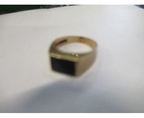 A 9 carat gold black onyx set ring, finger size M, 2.7g gross