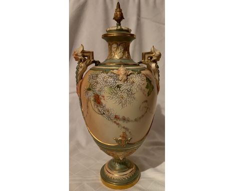 A Royal Worcester blush ivory covered vase, decorated with flowers, and having mask handles, shape number 1719, height 14.75i