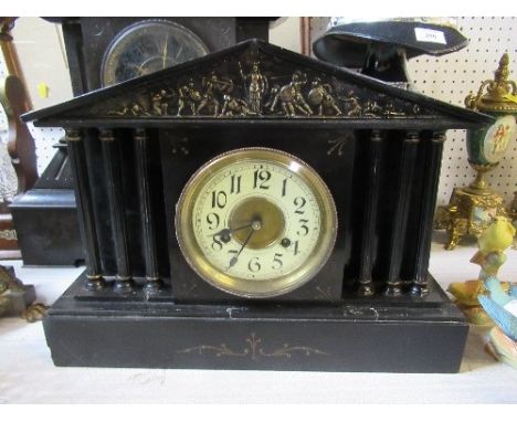 A 19th century black slate mantel clock, of architectural form, decorated with classical battle scene