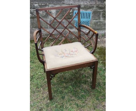 A Georgian mahogany Chinese Chippendale style armchair, with lattice to the back and bowed lattice to the arms, having a tape