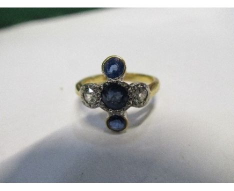 A sapphire and diamond 18 carat gold ring, the central sapphire with a sapphire above and below with a diamond to either side