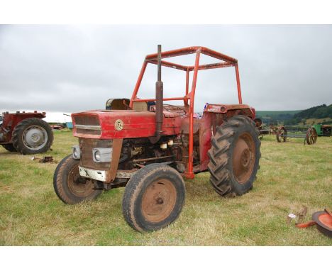 A Massey Ferguson 135 Diesel engined farm tractor with wishbone type front axle, swinging draw-bar and Secura roll-bar-frame.