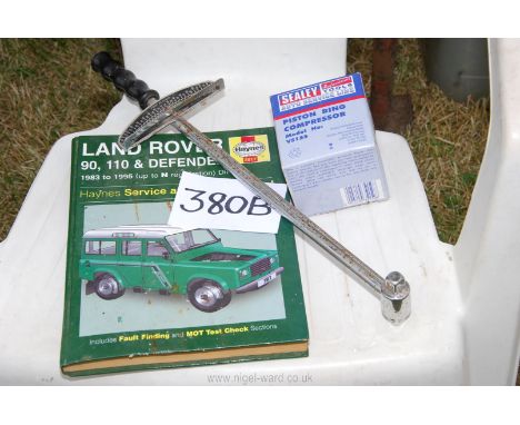 A Haines Landrover manual, a torque wrench and a piston ring compressor.