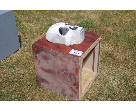 A wooden box / stand with fibre glass skull.