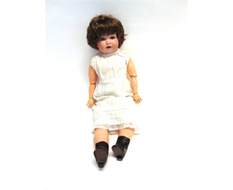 AN ARMAND MARSEILLE BISQUE SOCKET-HEAD DOLL with a replacement brown wig, sleeping grey glass eyes, and an open mouth with tw