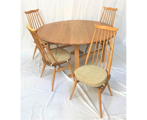 ERCOL LIGHT OAK CIRCULAR DINING SUITEthe table with drop flaps, standing on beech gate legs, 127cm wide, together with four E