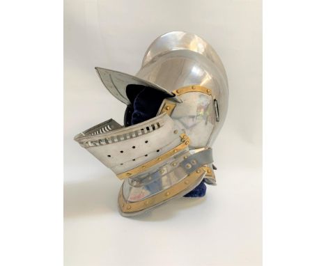 16TH CENTURY STYLE STEEL CLOSE HELMETwith a raised comb and one piece skull, with detachable hinged and pierced visor with de