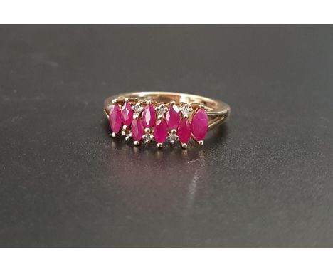 RUBY AND DIAMOND CLUSTER DRESS RINGthe seven marquise rubies at alternating higher and lower positions with small diamonds ab