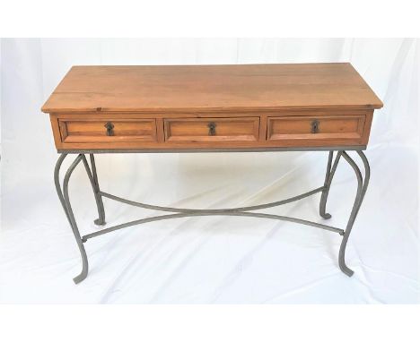 WAXED PINE CONSOLE TABLEwith an oblong top above three panelled frieze drawers, standing on shaped wrought iron supports unit