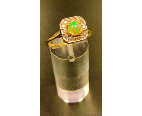 OPAL AND DIAMOND CLUSTER RINGthe central round cabochon opal in fourteen diamond surround, on eighteen carat gold shank, ring