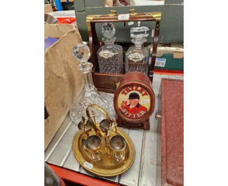 A mixed lot comprising tantalus and two decanters, ship's decanter, Tetley bitter light up sign and a silver plated egg cup s