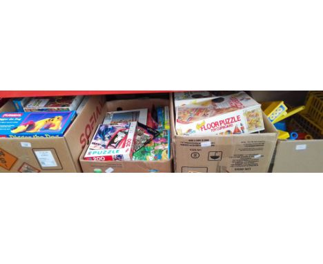 4 boxes of toys and games to include jigsaws, Floor puzzles, Playskool Digger the Dog, plastic kitchen and garden tools etc  