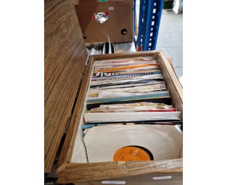 A box of 7" vinyl rock singles including Bob Dylan, U2, Bowie, Queen, Paul McCartney, Genesis, etc.  