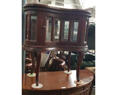 A mahogany drinks cabinet with tray top.  