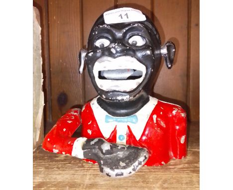 A cast metal money box. Note:- These items are listed on the basis they are illustrative of a bygone culture in which there w