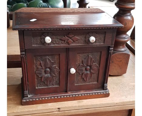 A Victorian carved oak miniature chiffonier/sideboard with ceramic handles. Dimensions- height 30.5cm, width 35cm and depth 1