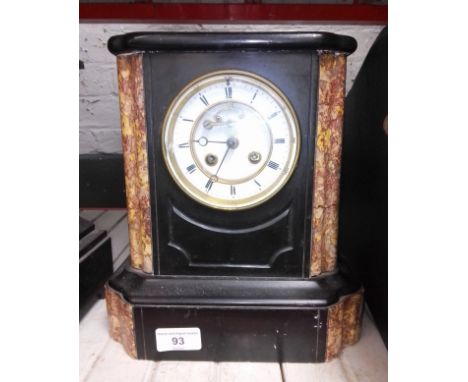 A small slate and marble mantle clock  