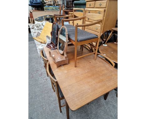 A mid 20th century teak extending dining table and six chairs including two carvers. Condition- some slight fading, marks and